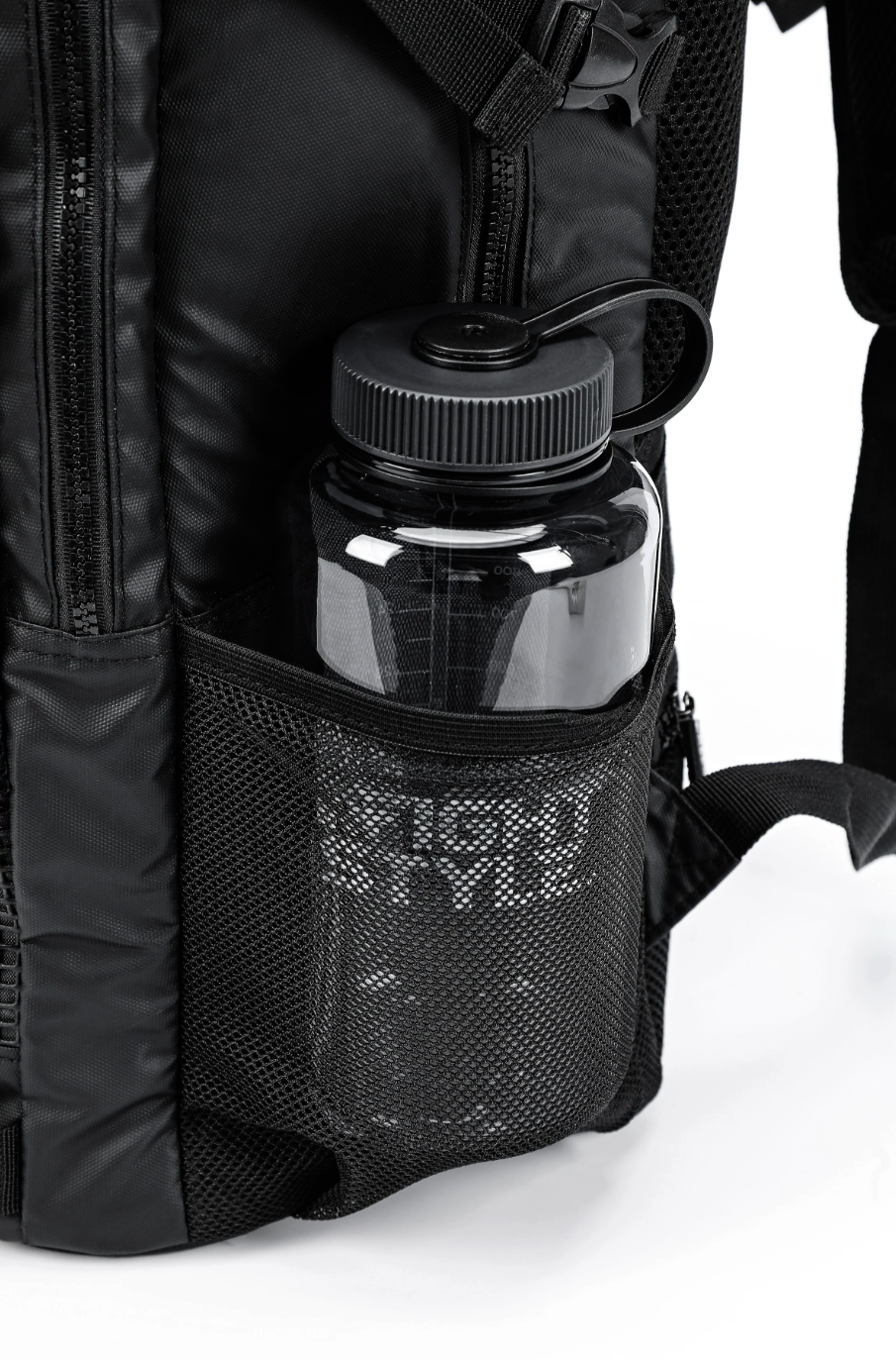 Black mesh pocket of the Ultimate Urban Trainer Backpack holding a water bottle, perfect for athletes on the go.