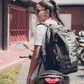 Stylish athlete wearing the Ultimate Urban Trainer Backpack by InfightStyle, ready for training on a motorcycle.