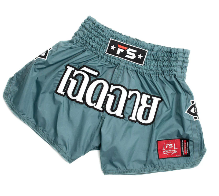 Teal Mono Nylon Lotus Granite Muay Thai training shorts with large white script logo and side patches.