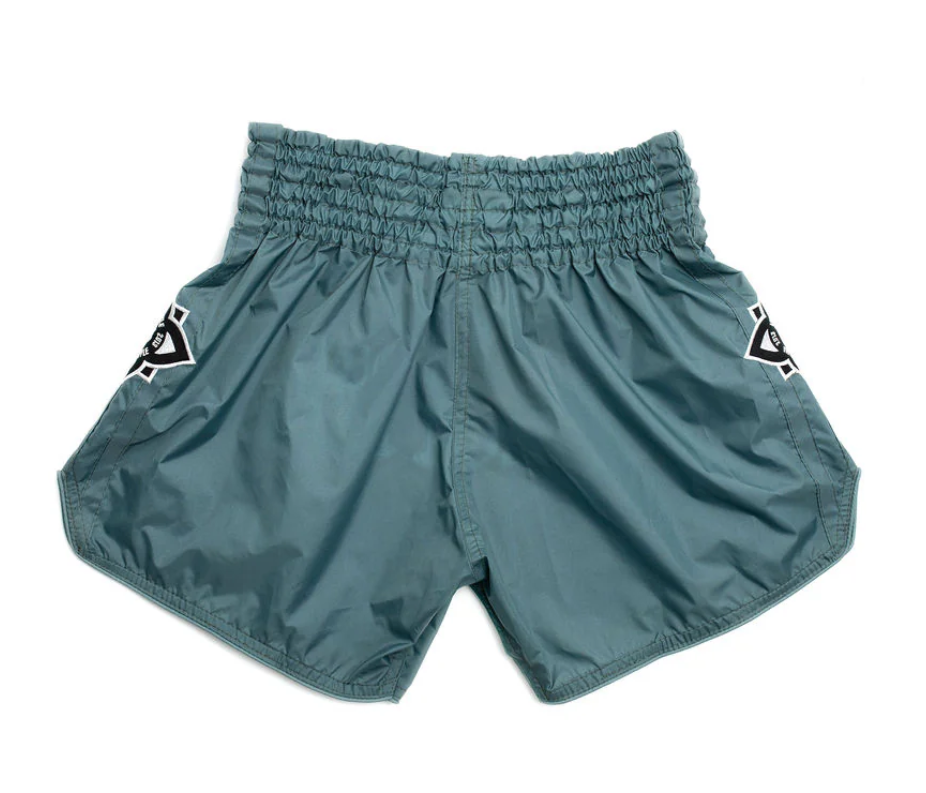 Mono Nylon Lotus Granite Muay Thai training shorts in teal nylon with elastic waistband and embroidered patches.